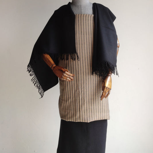 Mannequin wearing a black shawl over a beige striped women's woolen suit