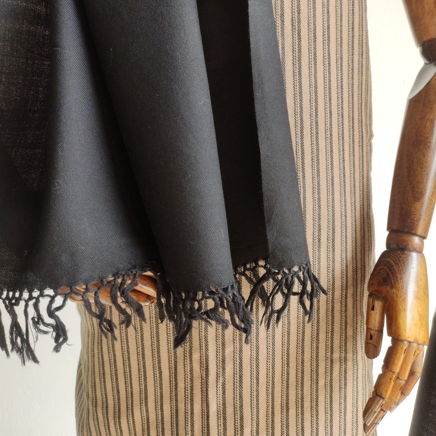 Mannequin wearing a black scarf with suit