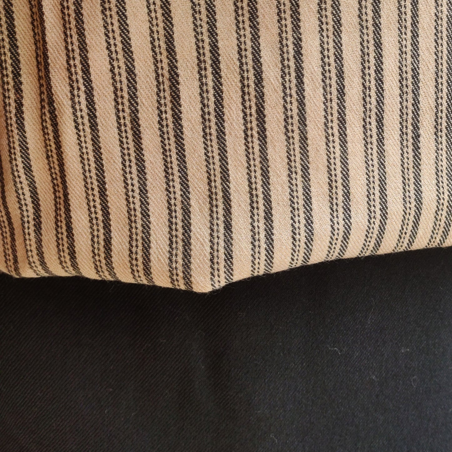 Close-up of striped beige women's woolen suit