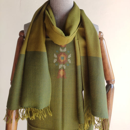 Green stole and suit with embroidery on a mannequin