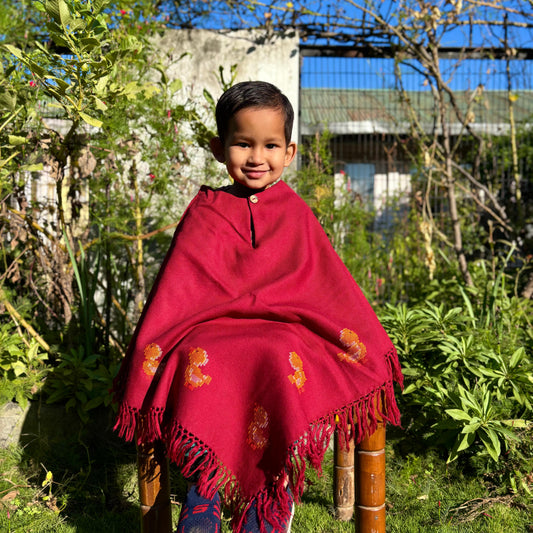 Handwoven kids poncho with duck motif and tassel edges in red color