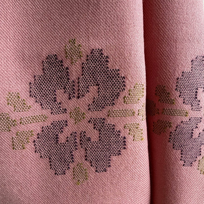 close up of motif on dusty pink merino wool stole
