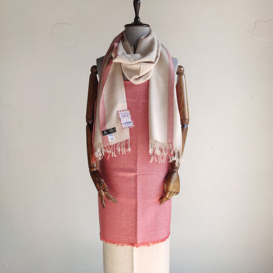 Mannequin wearing a woolen suit for women with a beige stole