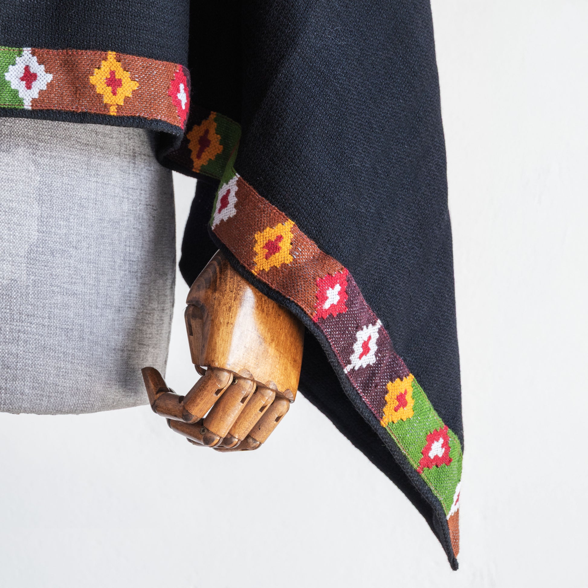 close up of Black woolen cape for women with kullu patti design