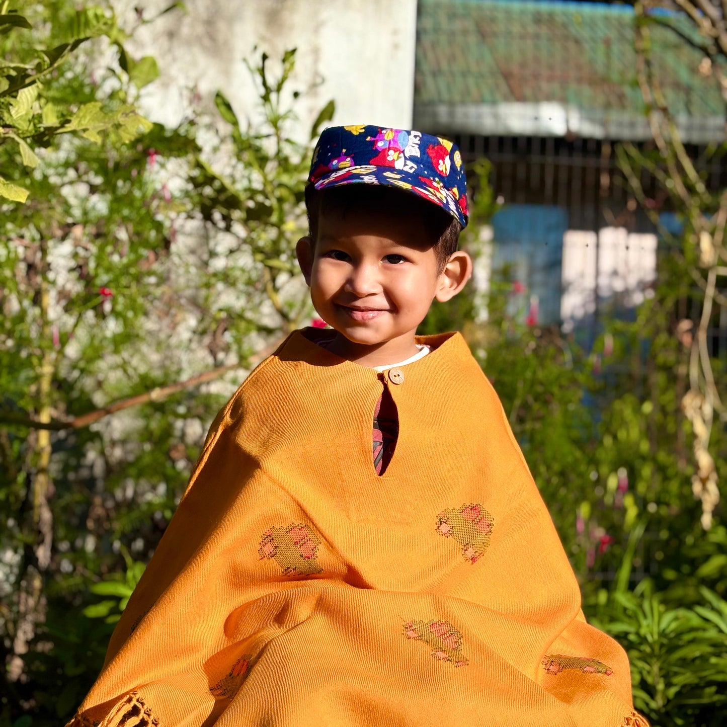 Child wearing a Sunshine Car Kids Poncho in mustard yellow