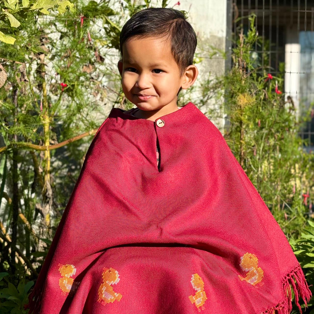 Handwoven kids poncho with duck motif and tassel edges